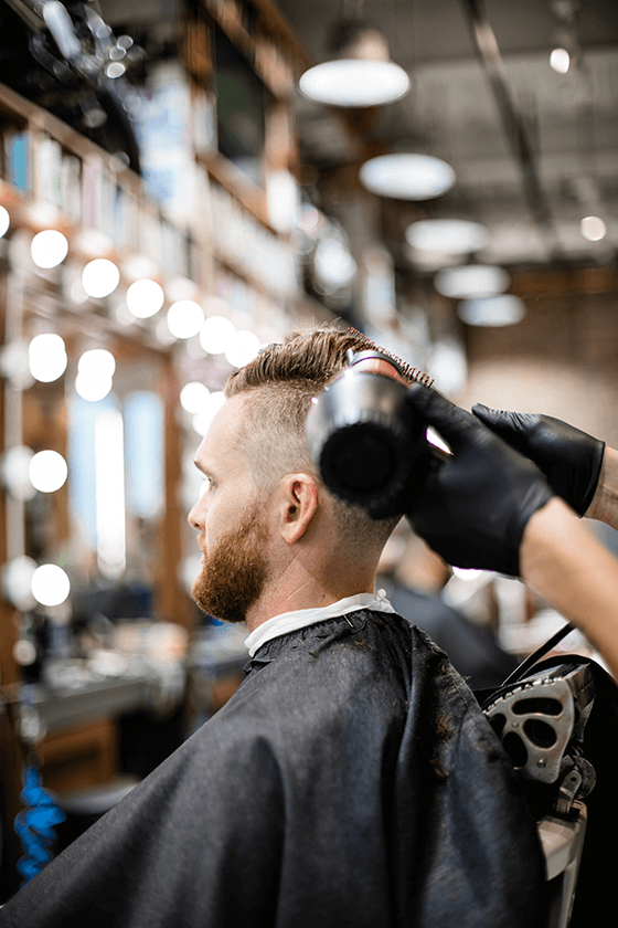 Barber cutting man hair